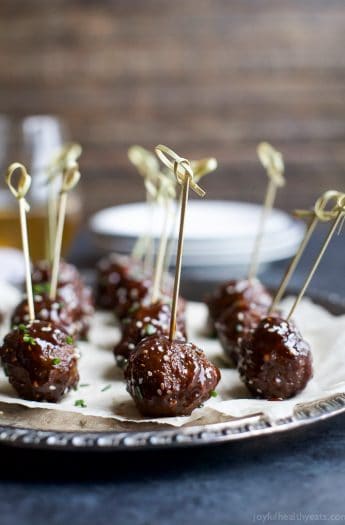 asian crockpot meatballs with skewers in them