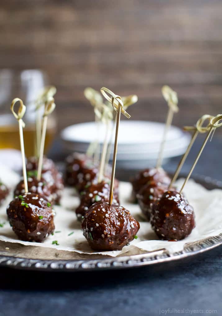 Asian Crockpot Meatballs covered in a sweet and spicy sauce you'll swoon over! An appetizer recipe you'll devour in seconds! 