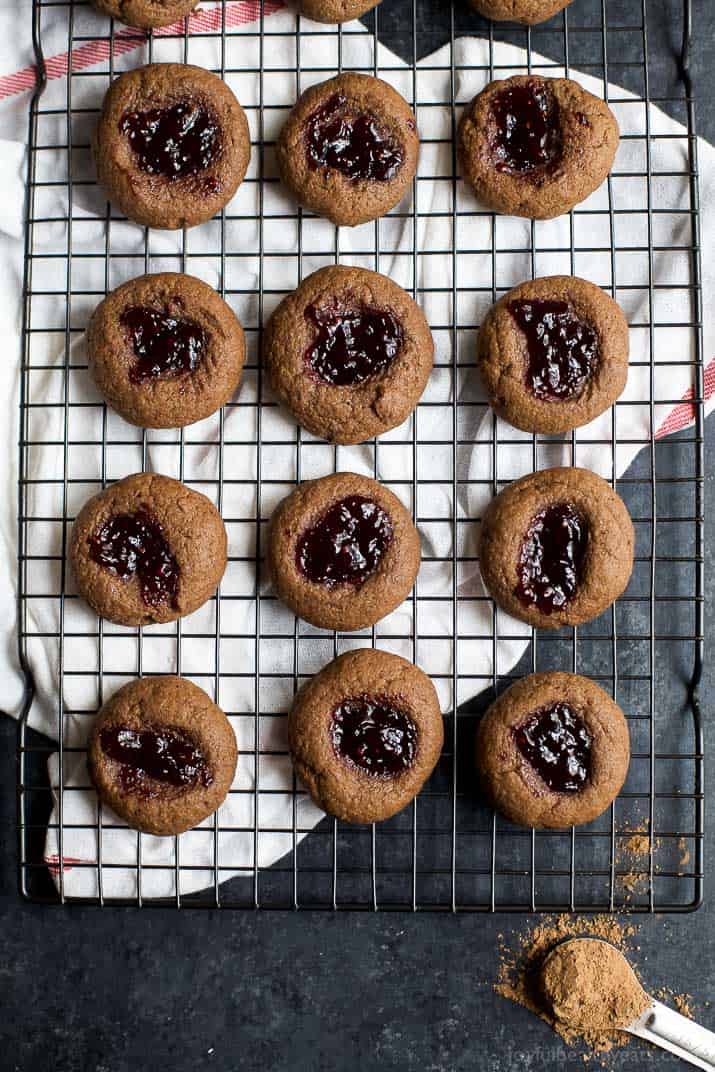 Top view of a dozen Chocolate Raspberry Thumbprint Cookies on a cooling rack