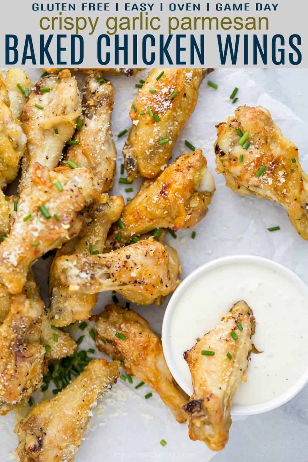 Crispy baked garlic parmesan chicken wings with a cup of creamy dipping sauce