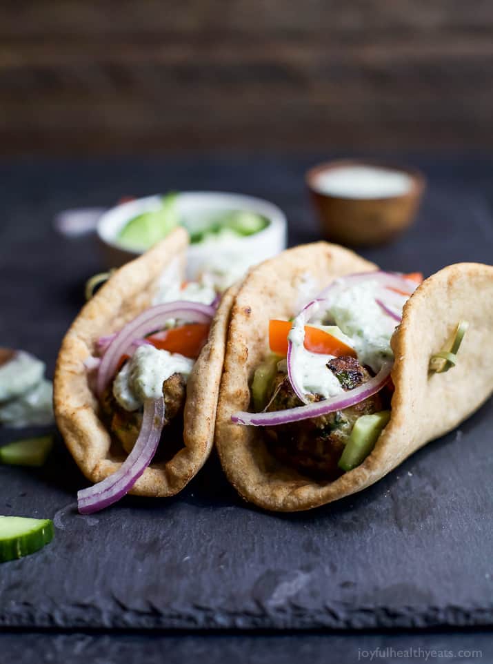 Two Greek Turkey Meatball Gyros topped with Tzatziki Sauce