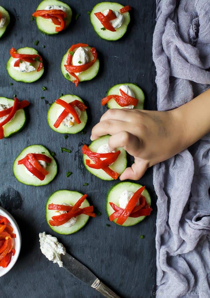 Fresh Simple Cucumber Bites topped with a zesty Herb Cream Cheese and sweet Piquillo Peppers. The perfect refreshing appetizer recipe for your next party! | joyfulhealthyeats.com #glutenfree #vegetarian