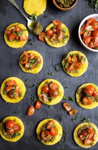 Crispy Polenta Bites with a Basil Pesto spread and topped with fresh Tomato Bruschetta. | Gluten Free Recipes | Vegetarian Recipes | joyfulhealthyeats.com