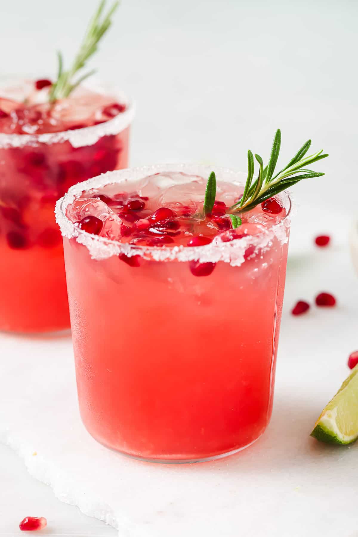 Pomegranate margarita with ice and pomegranate seeds.