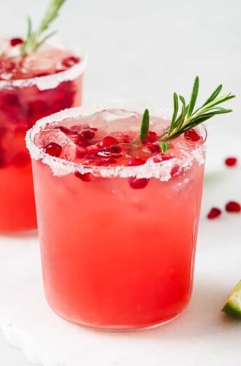 Pomegranate margarita with ice and pomegranate seeds.