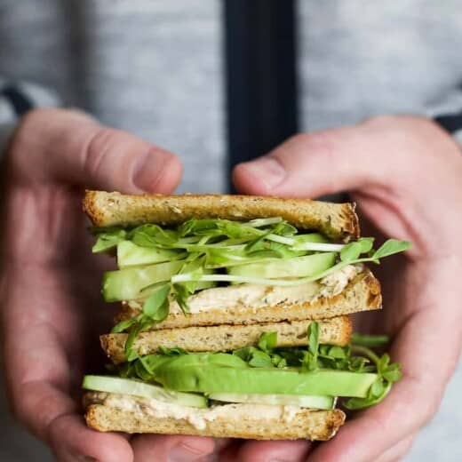 stacked cucumber avocado sandwich with herb goat cheese