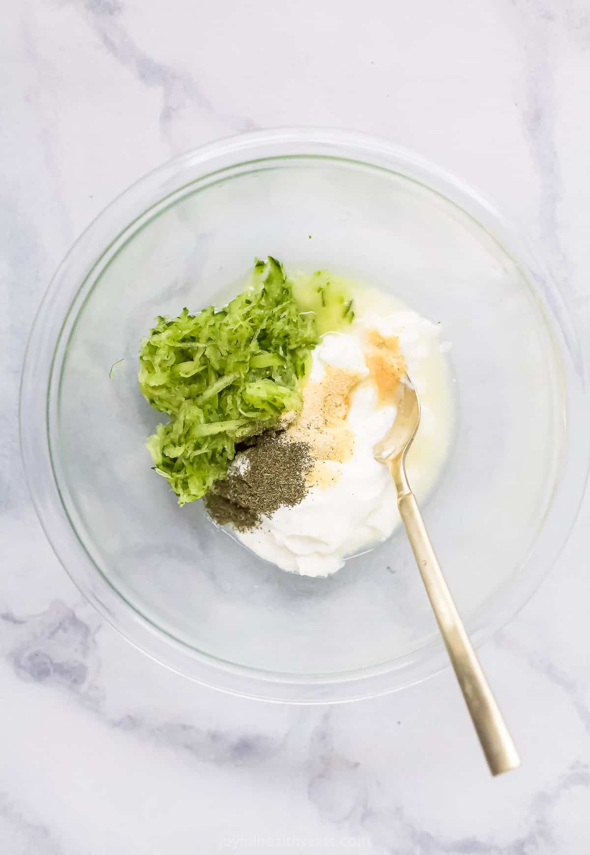 tzatziki sauce ingredients in a glass bowl