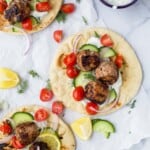 Overhead view of greek turkey meatball gyros with tomatoes and cucumber