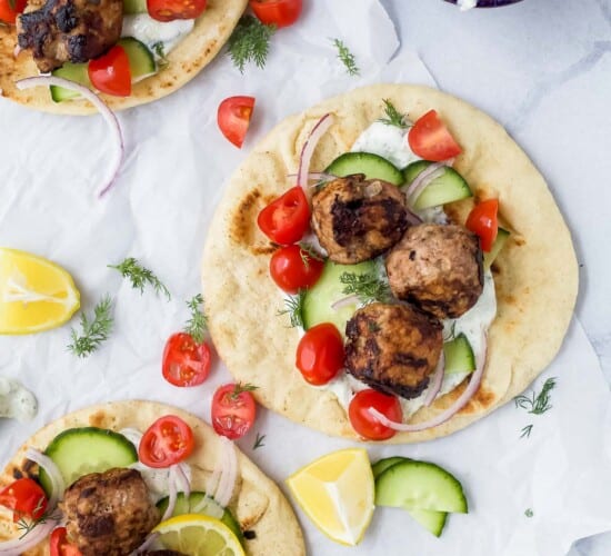 Overhead view of greek turkey meatball gyros with tomatoes and cucumber