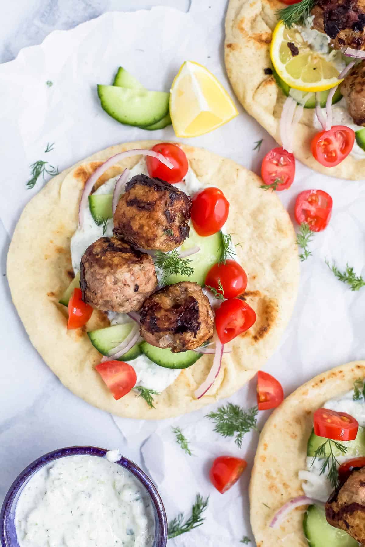 Overhead view of a Greek turkey meatball gyro with tomatoes, cucumber, and tzatziki
