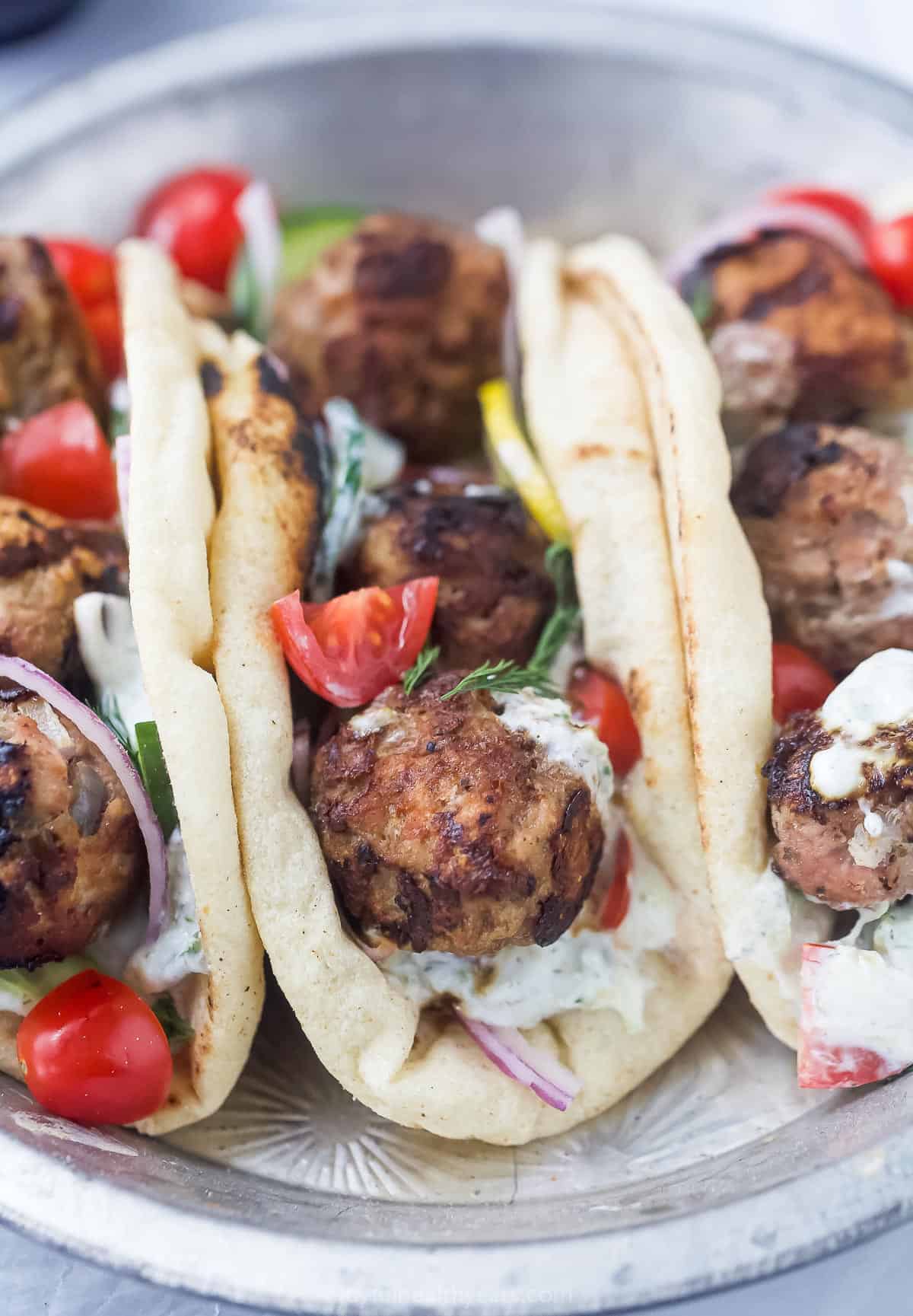 3 turkey meatball gyros folded with tomato and tzatziki