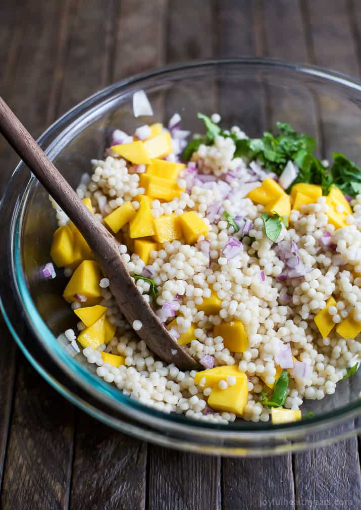 An Easy Mango Couscous Salad packed with sweet mango and a light dressing. This salad is a quick 15 minute side dish you're family will love, perfect with seafood or chicken. | joyfulhealthyeats.com