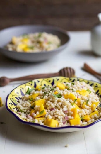 An Easy Mango Couscous Salad packed with sweet mango and a light dressing. This salad is a quick 15 minute side dish you're family will love, perfect with seafood or chicken. | joyfulhealthyeats.com