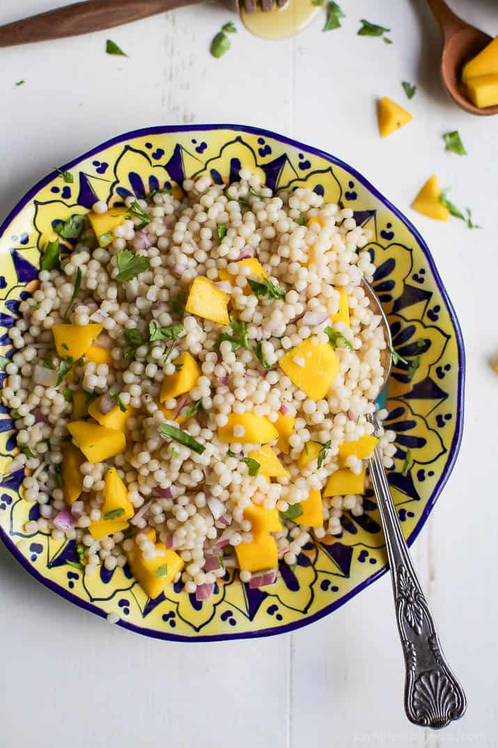 An Easy Mango Couscous Salad packed with sweet mango and a light dressing. This salad is a quick 15 minute side dish you're family will love, perfect with seafood or chicken. | joyfulhealthyeats.com