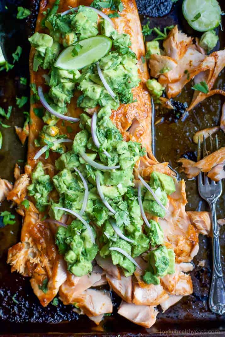 Paleo Baked Salmon that's rubbed down with a sweet & spicy spice blend then topped with a fresh zesty Avocado Salsa! This easy healthy recipe is done in less than 30 minutes! | joyfulhealthyeats.com
