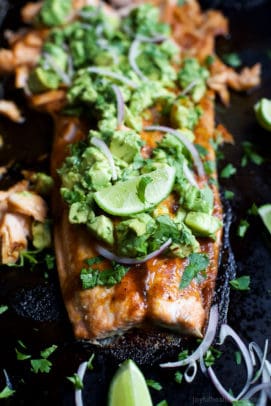 Paleo Baked Salmon that's rubbed down with a sweet & spicy spice blend then topped with a fresh zesty Avocado Salsa! This easy healthy recipe is done in less than 30 minutes! | joyfulhealthyeats.com