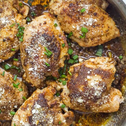 Parmesan chicken thighs with garlic butter sauce.