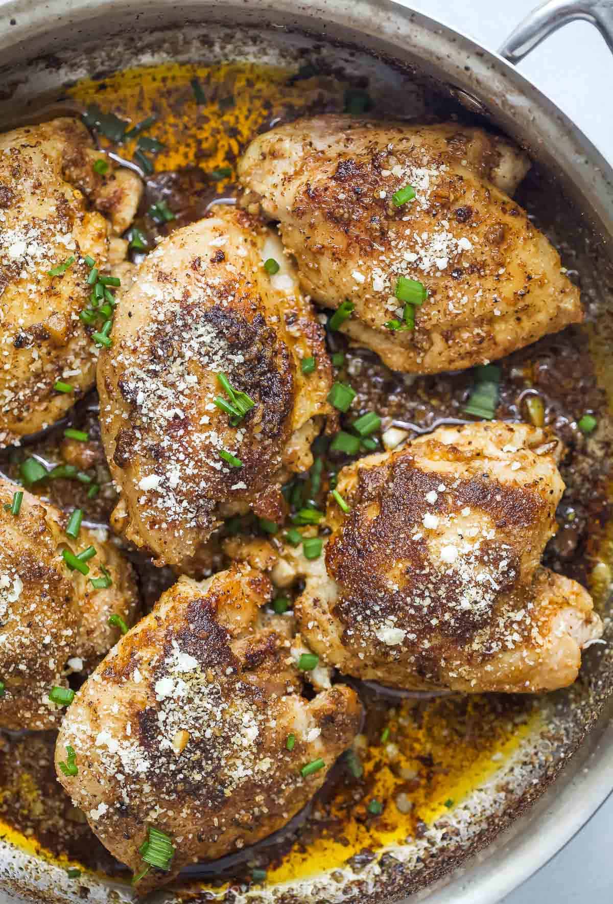 Parmesan chicken thighs with garlic butter sauce.