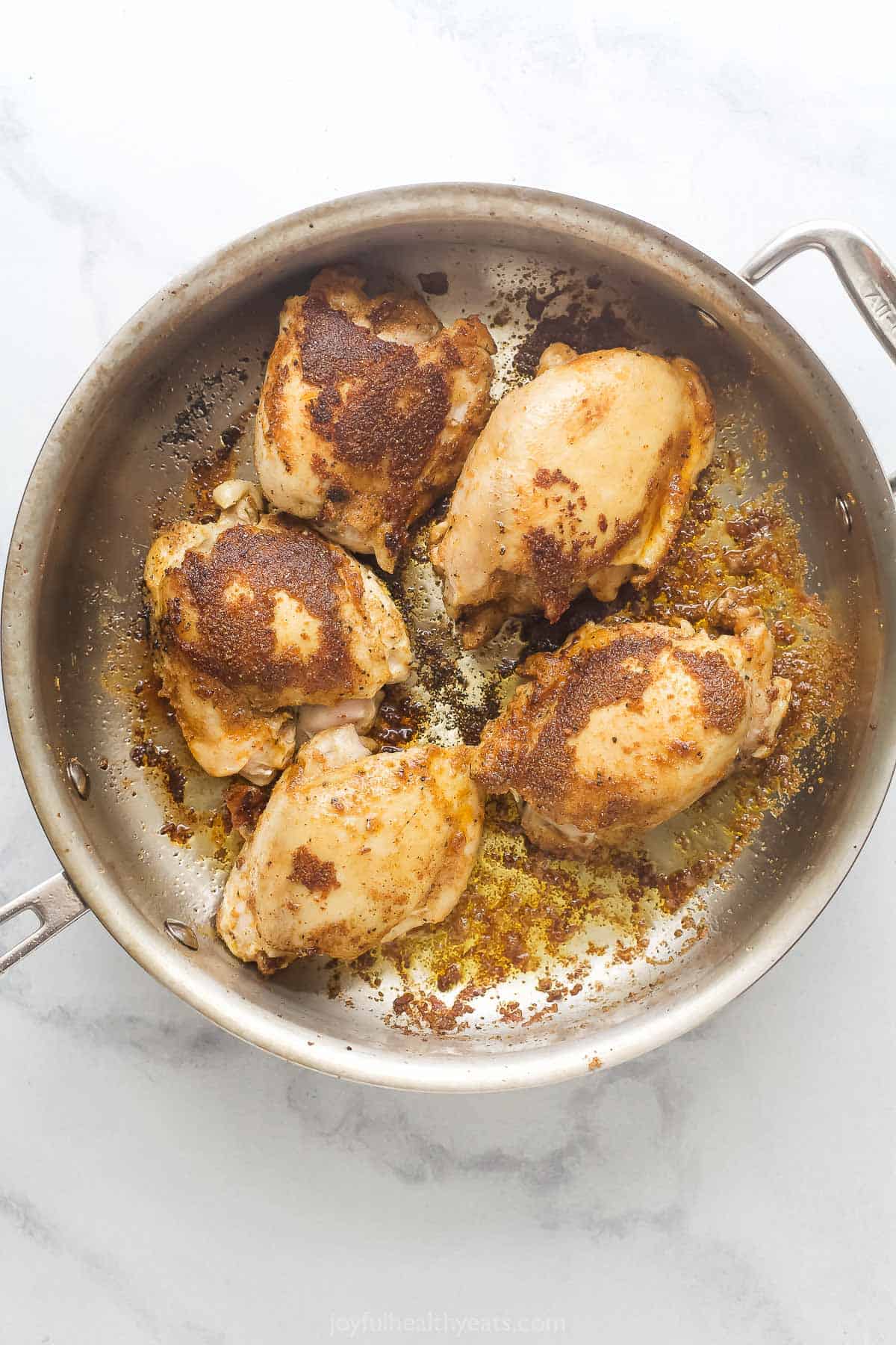 Browning the chicken in the pan. 