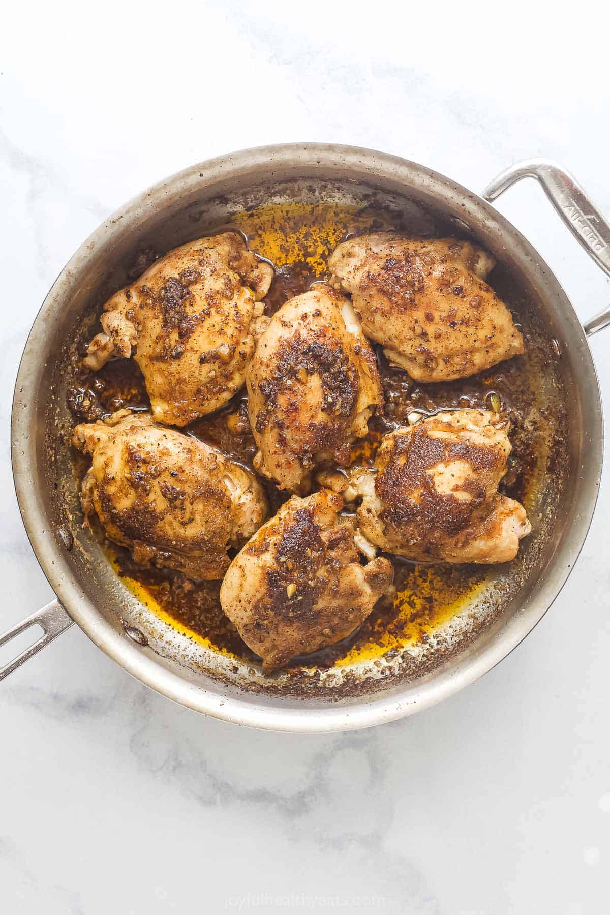 Simmering the chicken with the sauce. 