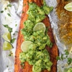 baked salmon in foil with avocado salsa on top