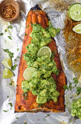 baked salmon in foil with avocado salsa on top