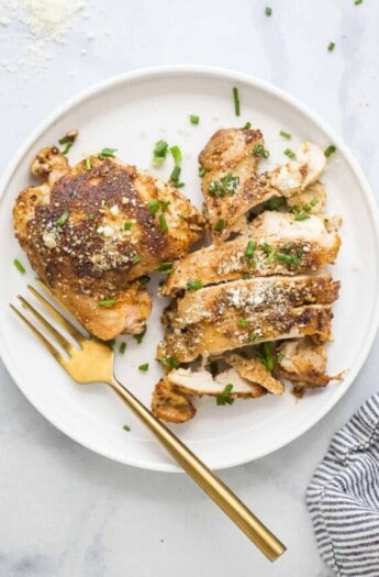 Sliced chicken thighs on a plate.