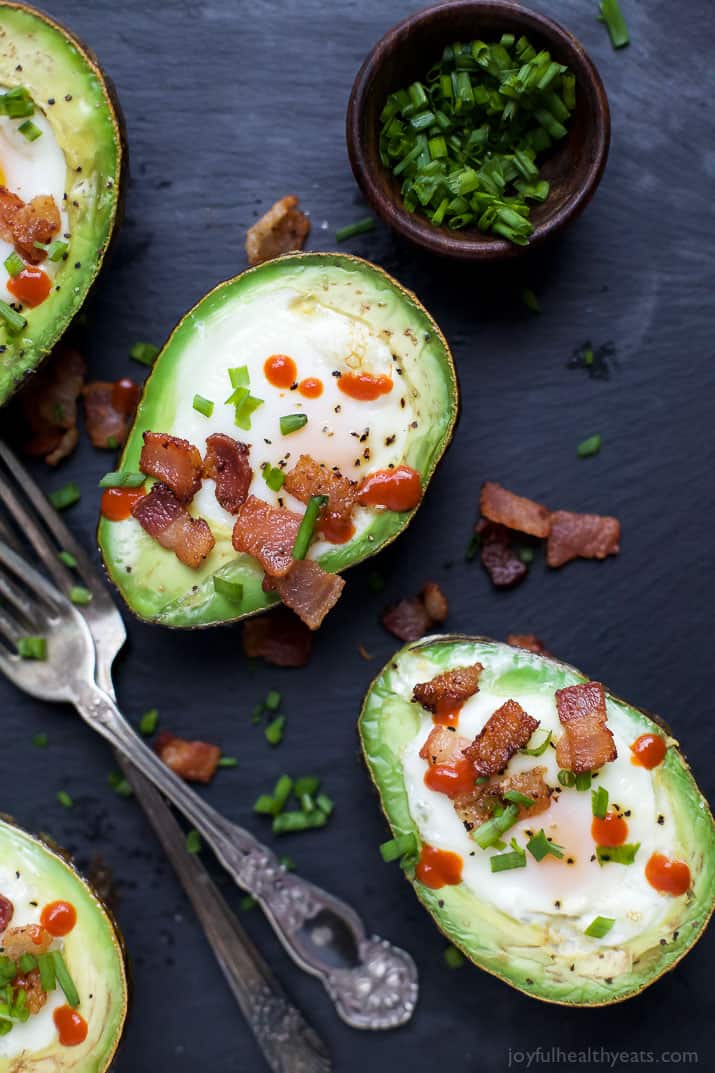 BAKED EGGS IN AVOCADO with crispy bacon and a Sriracha drizzle