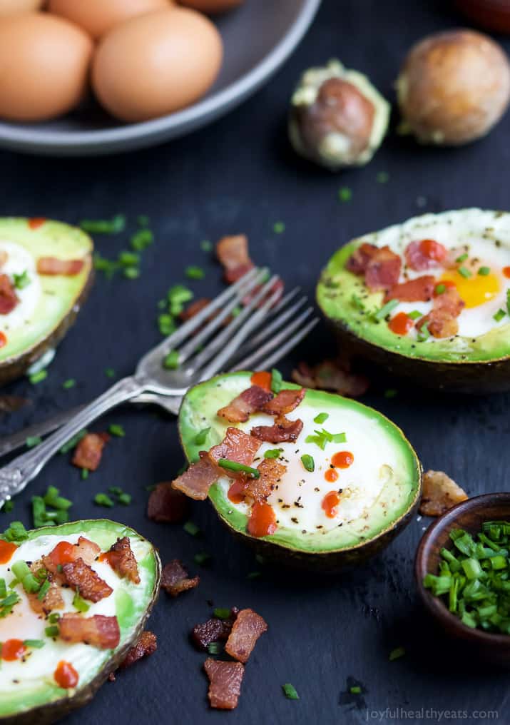 BAKED EGGS IN AVOCADO with crispy bacon and a Sriracha drizzle