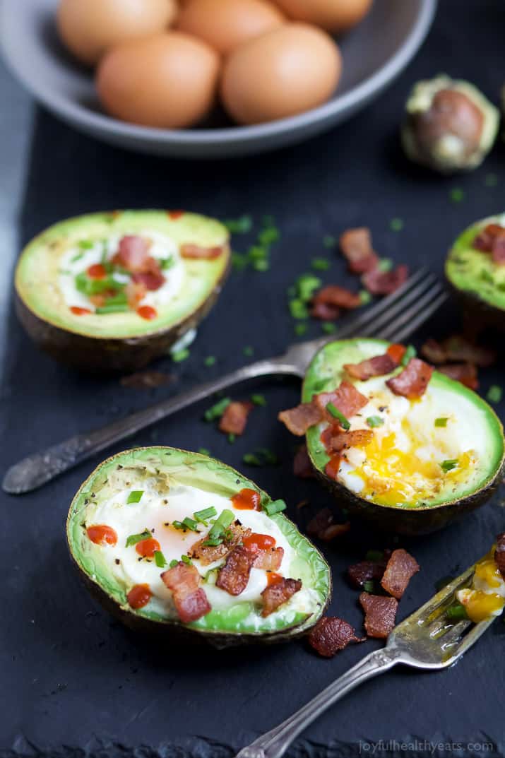 BAKED EGGS IN AVOCADO with crispy bacon and a Sriracha drizzle