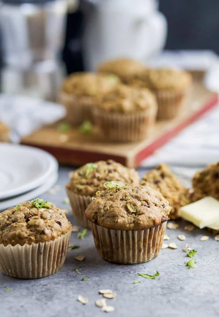 Chocolate Chip Zucchini Muffins on a countertop and cutting board