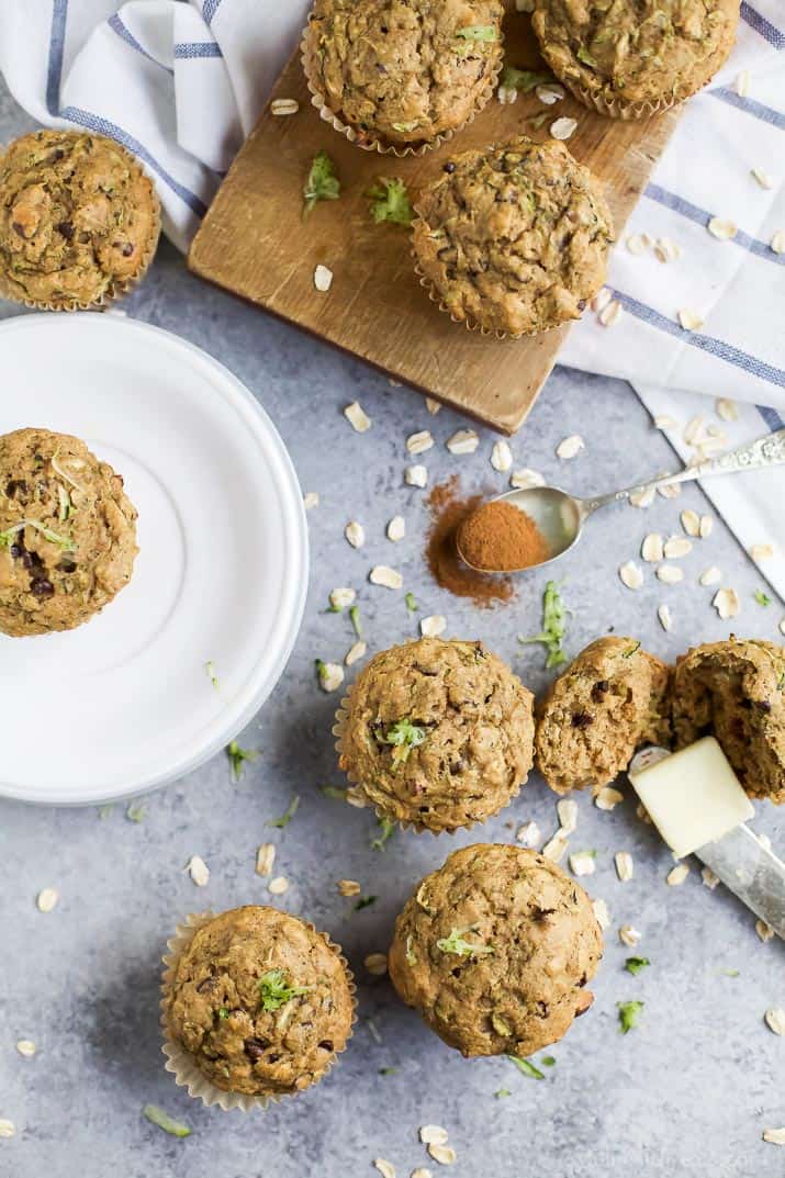 Top view of Chocolate Chip Zucchini Muffins on a plate, cutting board, and countertop