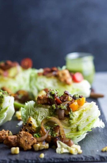 SOUTHWESTERN WEDGE SALAD with seasoned chicken, bacon, onion rings, charred corn a POBLANO DRESSING you'll adore. The wedge salad only takes 30 minutes to make & is under 400 calories a serving! | joyfulhealthyeats.com | Gluten Free Recipes