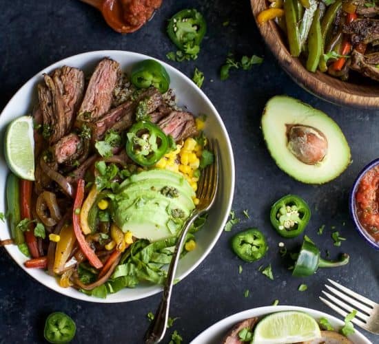 a display of burrito bowls made with vegetables and sliced steak