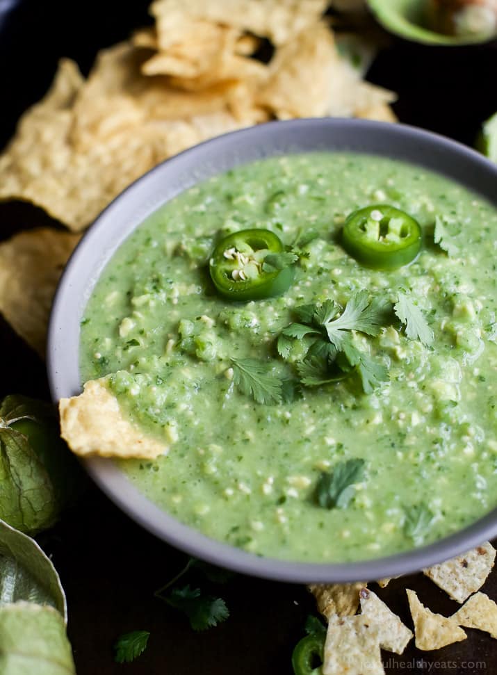 A bowl of Avocado Salsa Verde with jalapeno slices and fresh cilantro