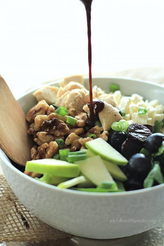 A Feta Chicken Salad Being Drizzled with Honey Balsamic Vinaigrette