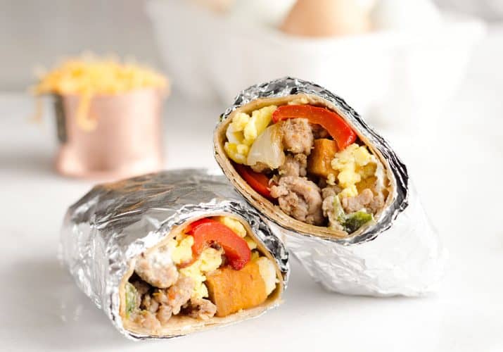 Light & Spicy Turkey Sausage Breakfast Burritos are a healthy freezer-friendly breakfast full of lean Jennie-O turkey sausage, scrambled eggs and roasted vegetables.