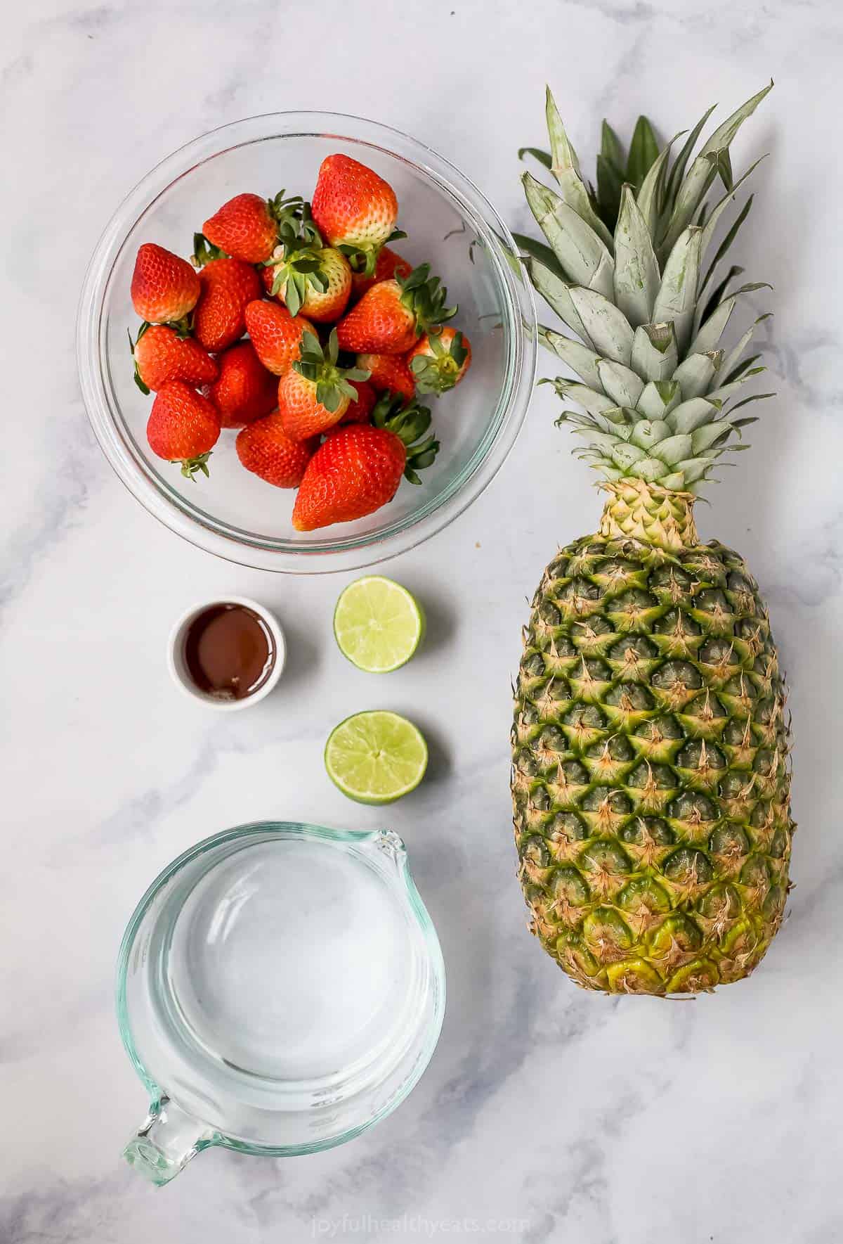 Overhead view of pineapple strawberry agua fresca ingredients