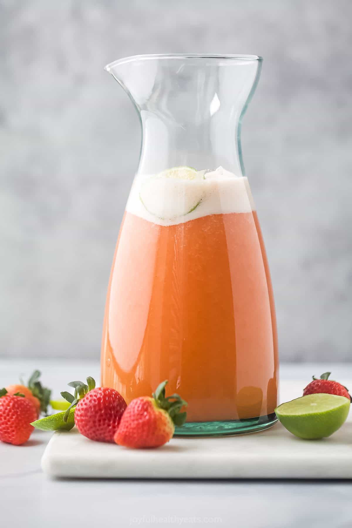 A pitcher of strawberry pineapple agua fresca