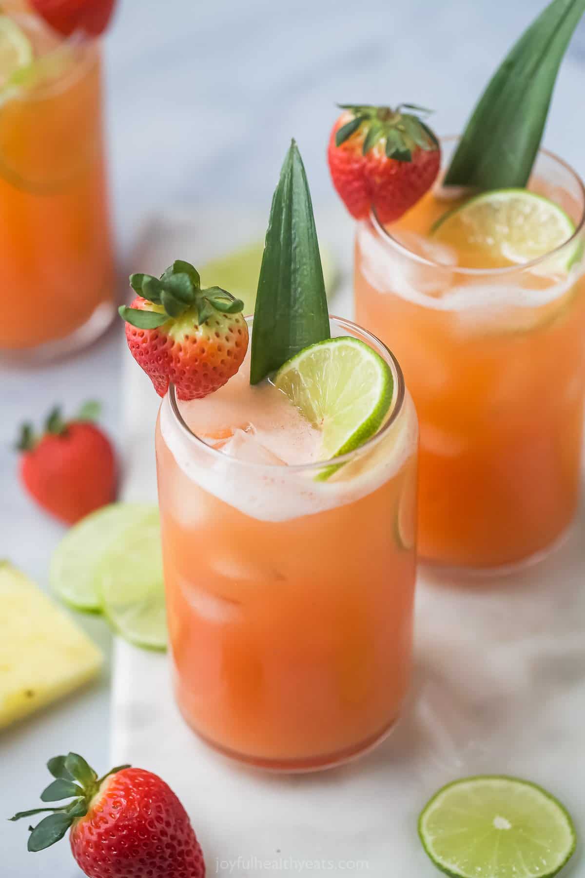 Overhead view of glasses of pineapple strawberry agua fresca