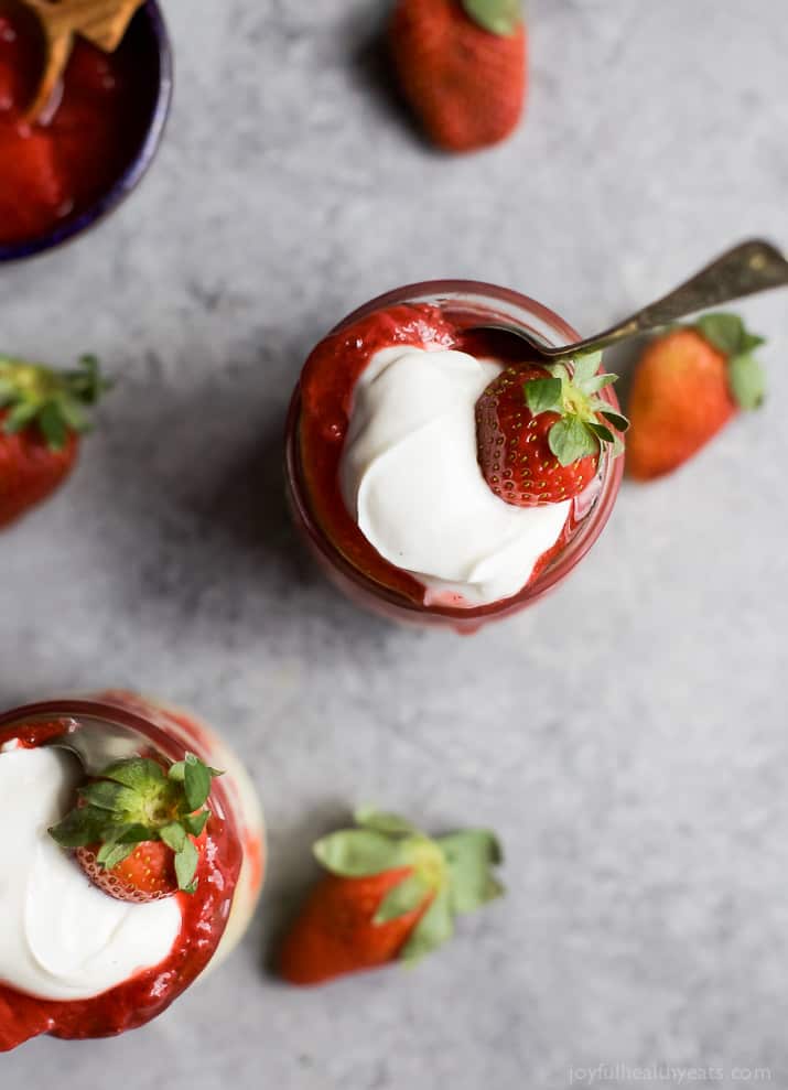 SKINNY CHEESECAKE for two made with greek yogurt and topped with fresh strawberries slightly sweetened with honey. The perfect healthy sweet dessert for those late night cravings! | joyfulhealthyeats.com