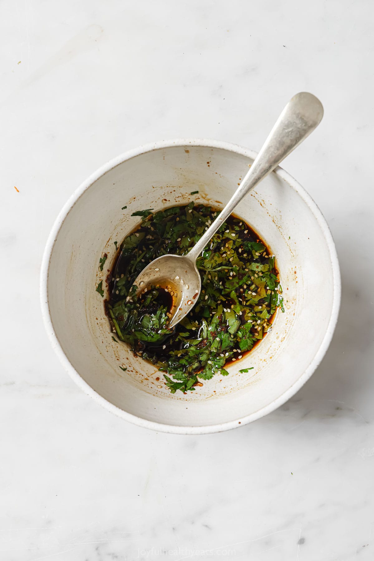 Mixing the dressing in a bowl. 