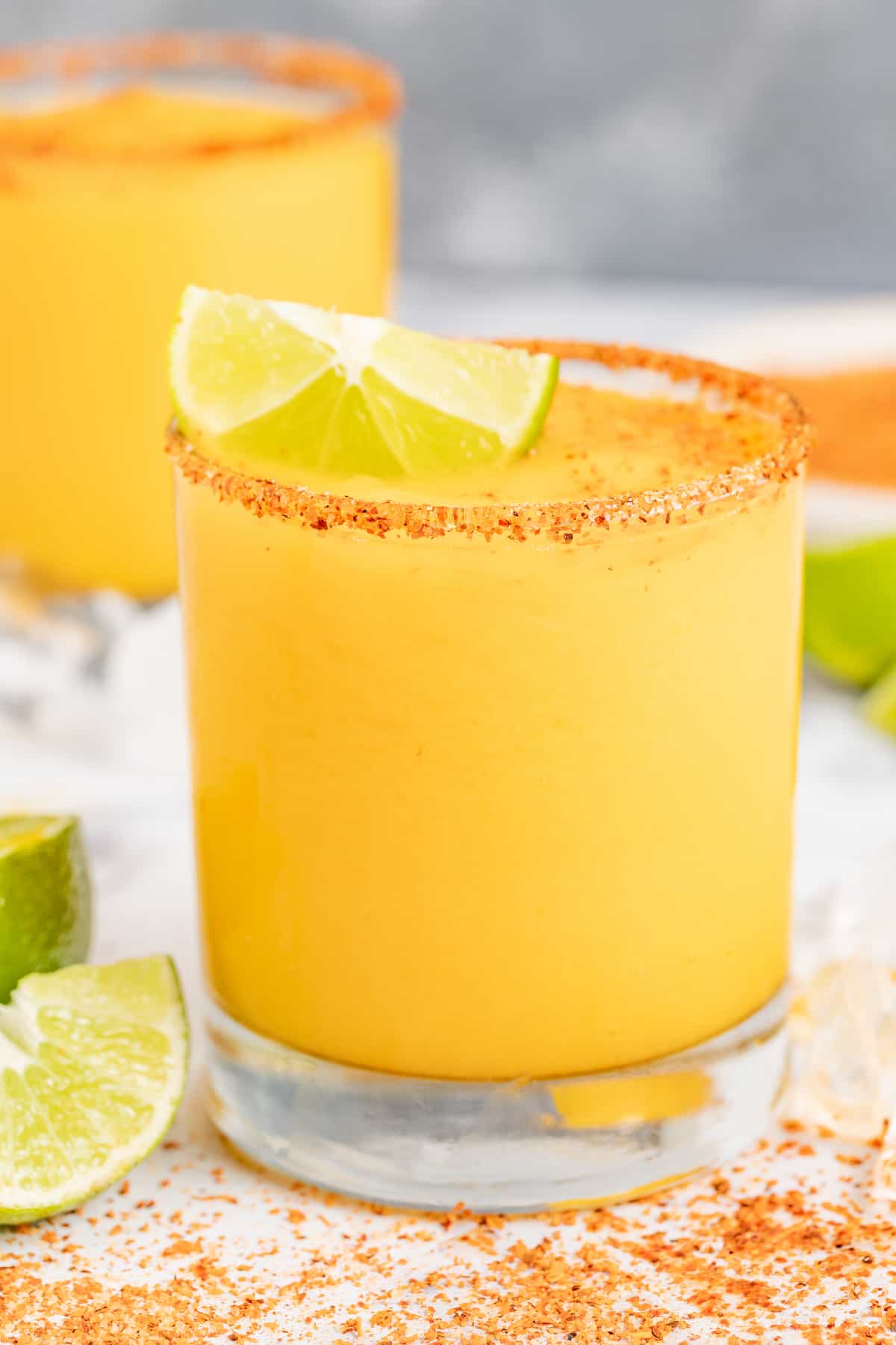 Served in chili-rimmed glasses, this frozen mango margarita is the boozy, tropical drink you need to beat the heat this summer. Two frozen mango margaritas.