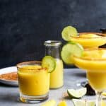 Easy FROZEN MANGO MARGARITAS with a chili lime salt rim! The perfect cocktail recipe to keep you cool this summer!