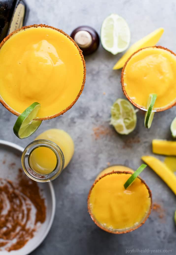 Top view of Frozen Mango Margaritas with a chili lime salt rim