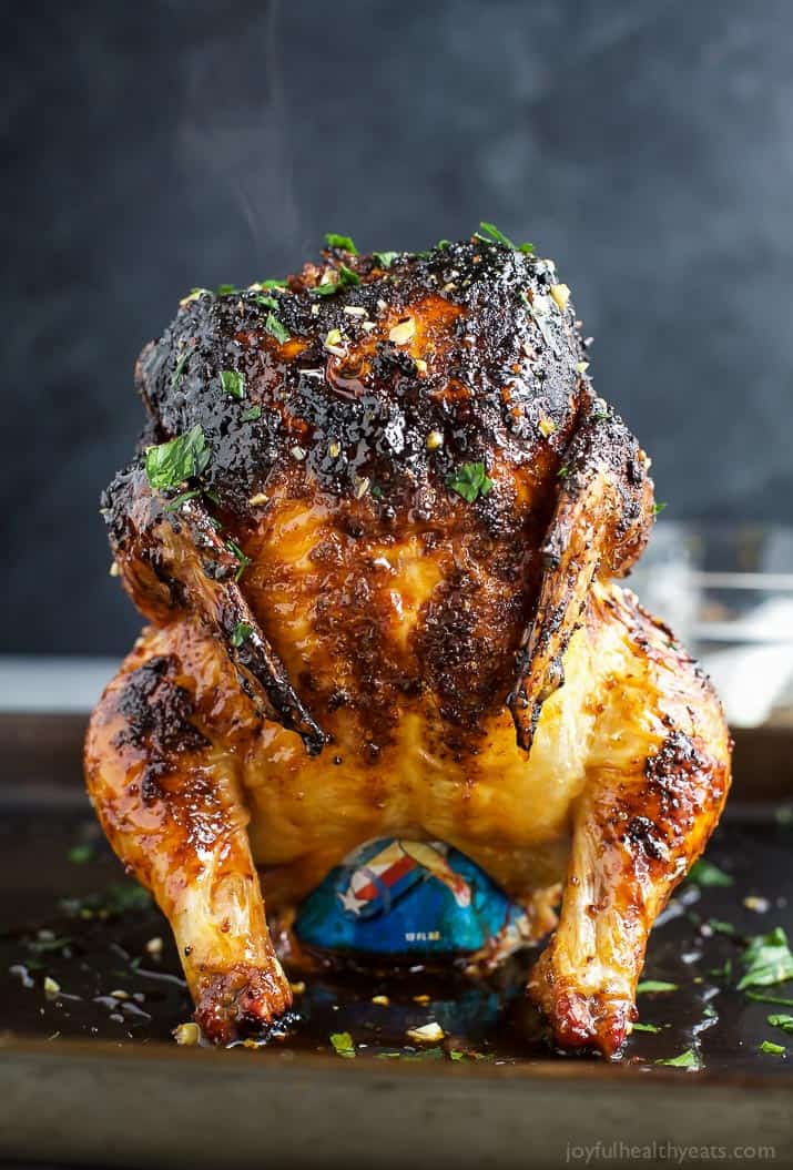 Glazed Honey Garlic Beer Can Chicken standing upright on a baking pan