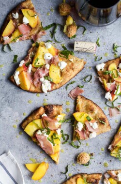 Grilled Flatbread Pizza topped with Peaches, Prosciutto, Goat Cheese, and fresh Basil! The ultimate summer grilling recipe done in just 30 minutes!