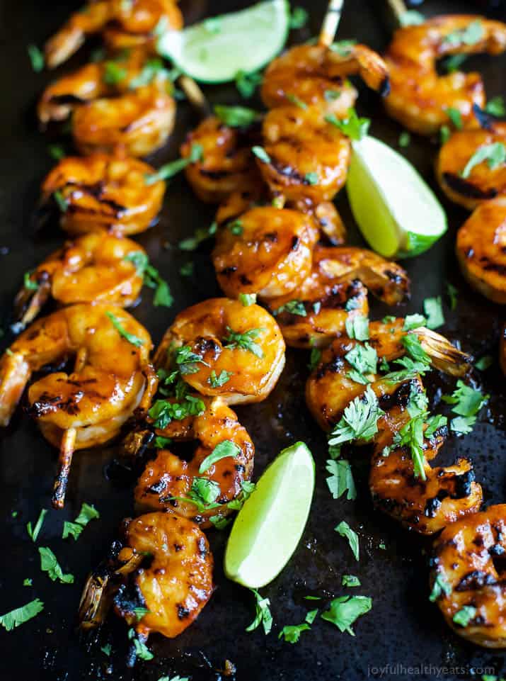 A close-up shot of honey sriracha shrimp on top of a large pan