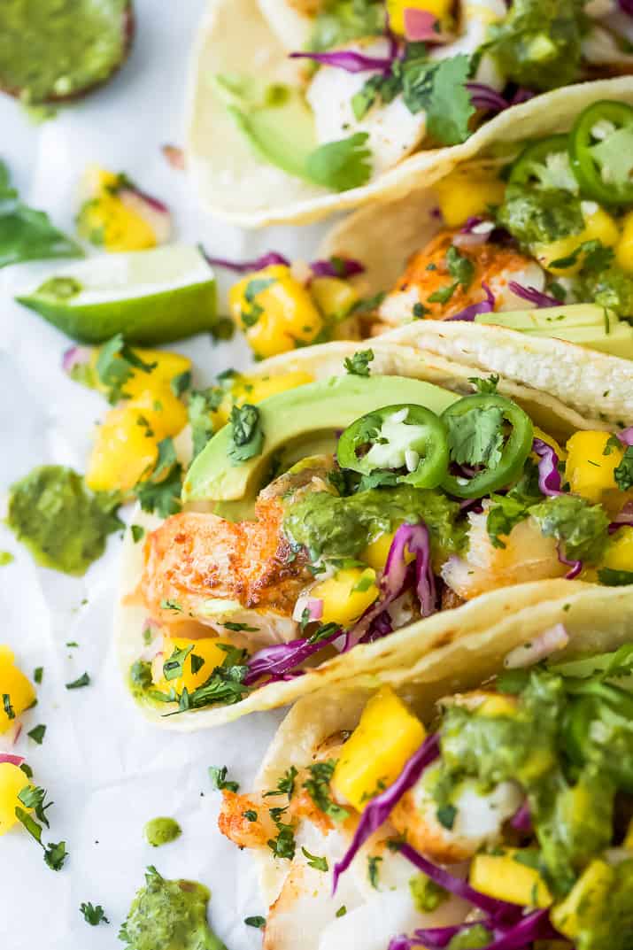 Close-up of fish tacos with mango salsa, avocado and garnishes