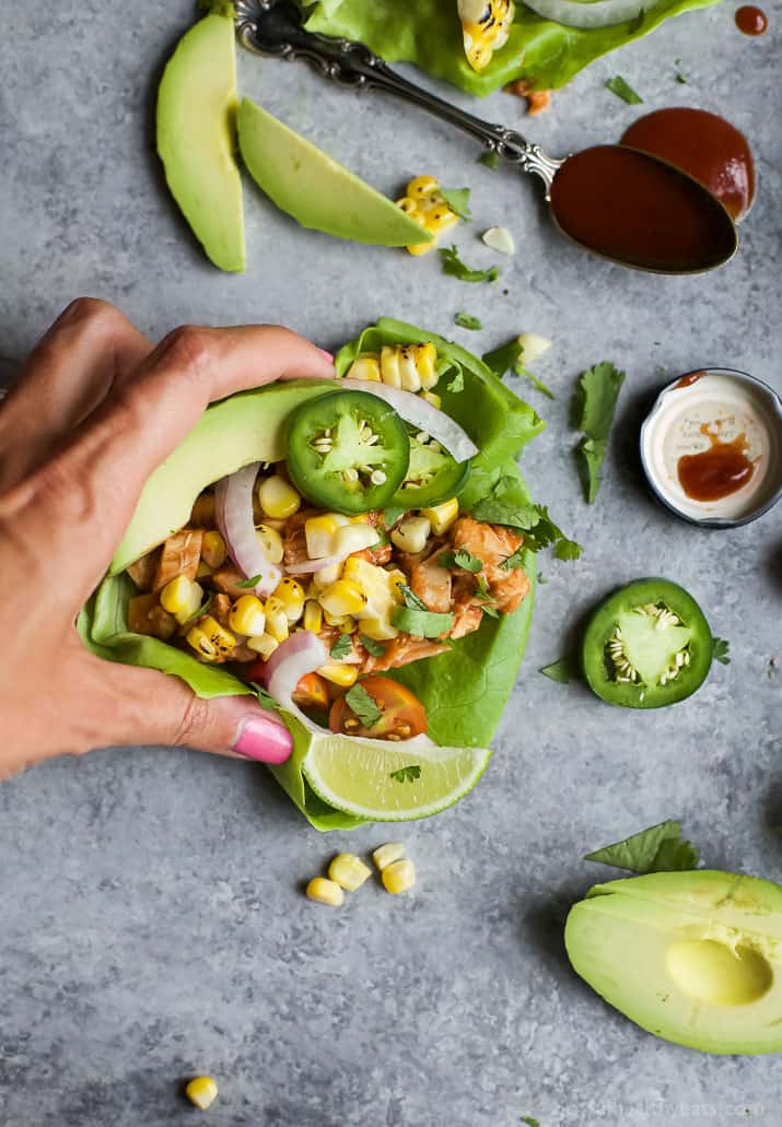 A hand picking up a 20 Minute BBQ Chicken Taco